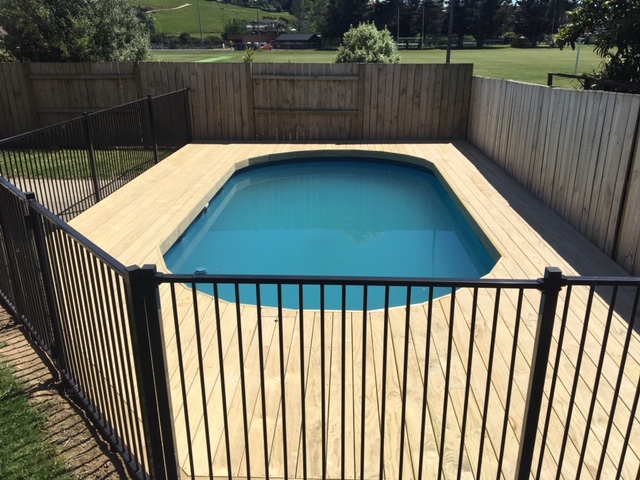 Pool with wooden deck around it