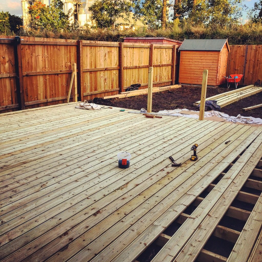 Wooden deck being layed in back garden. This image was taken on a mobile device