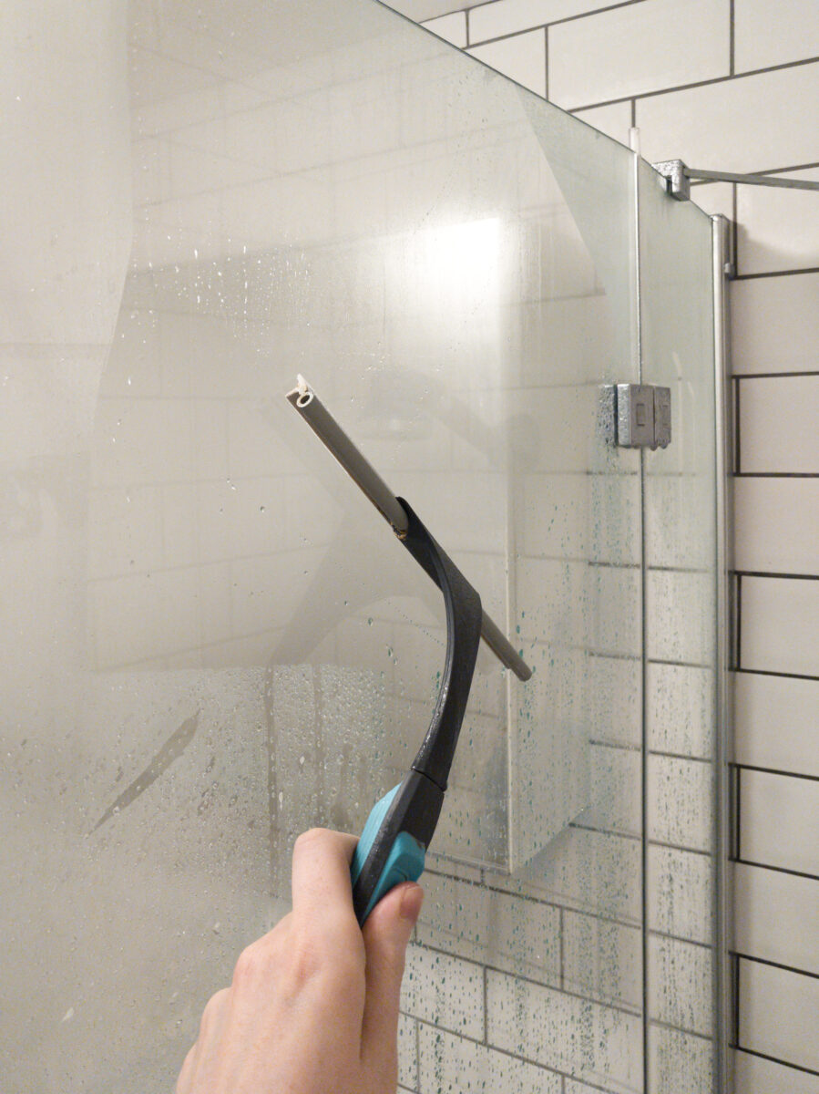 Keeping shower glass clean by wiping it down