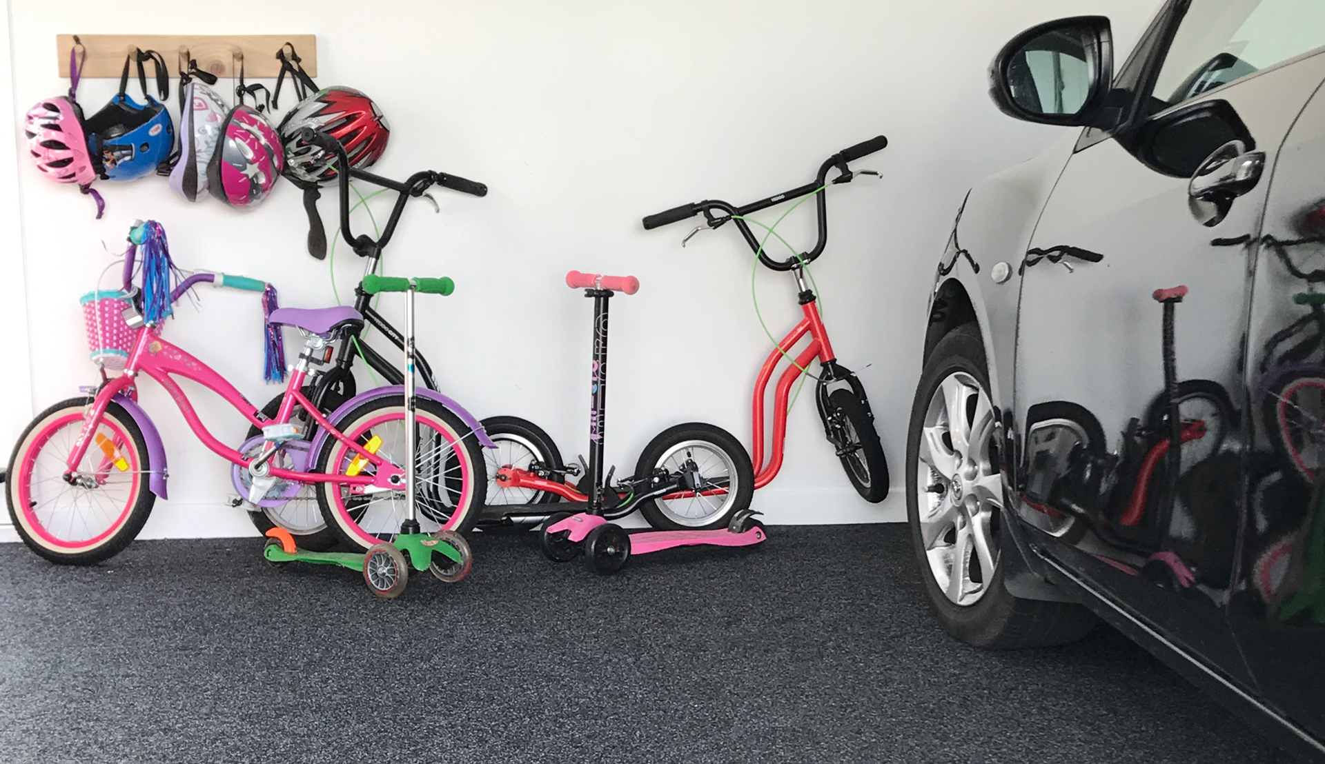 Carpeted garage with kids bikes against wall