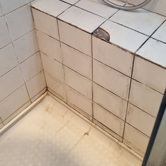 Cracked tile in shower before
