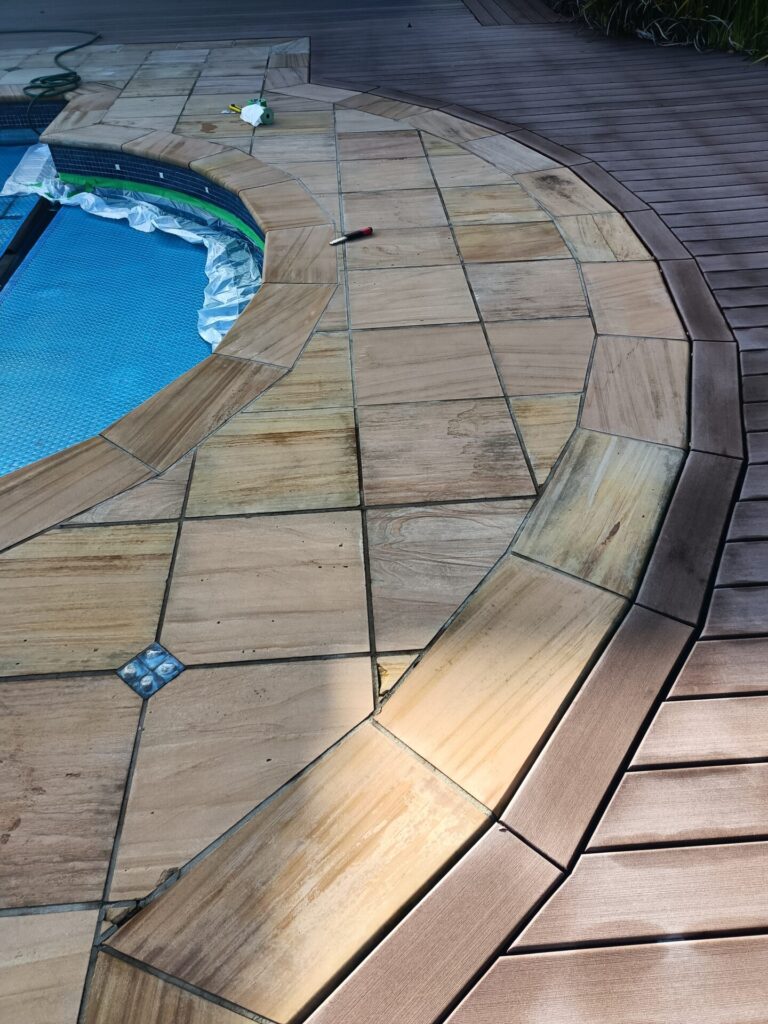 Tiles around swimming pool needing restoration