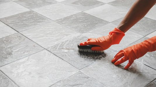 A homeowver cleaning their tile floor