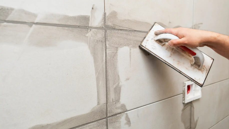 someone regrouting kitchen tiles