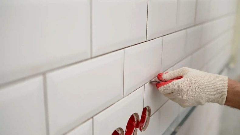 Old grout being removed from kitchen tiles