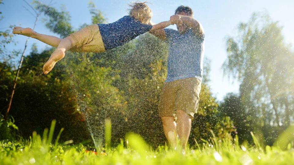 Dad and son playing on artificial grass